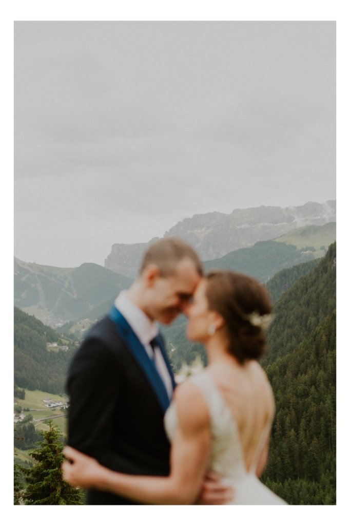 bride and groom holding each other dolomites view