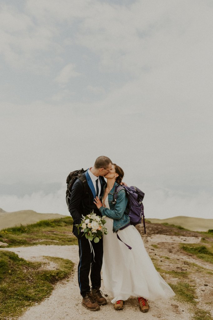 bride and groom kissing landscape