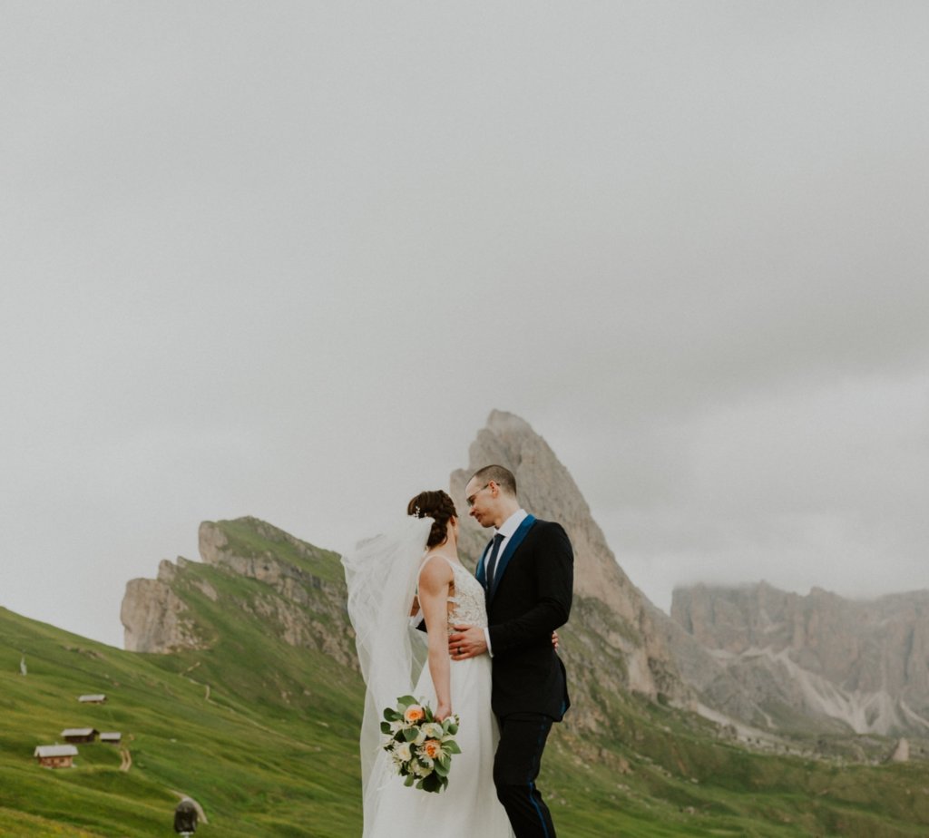 bride and groom holding each other dolomites