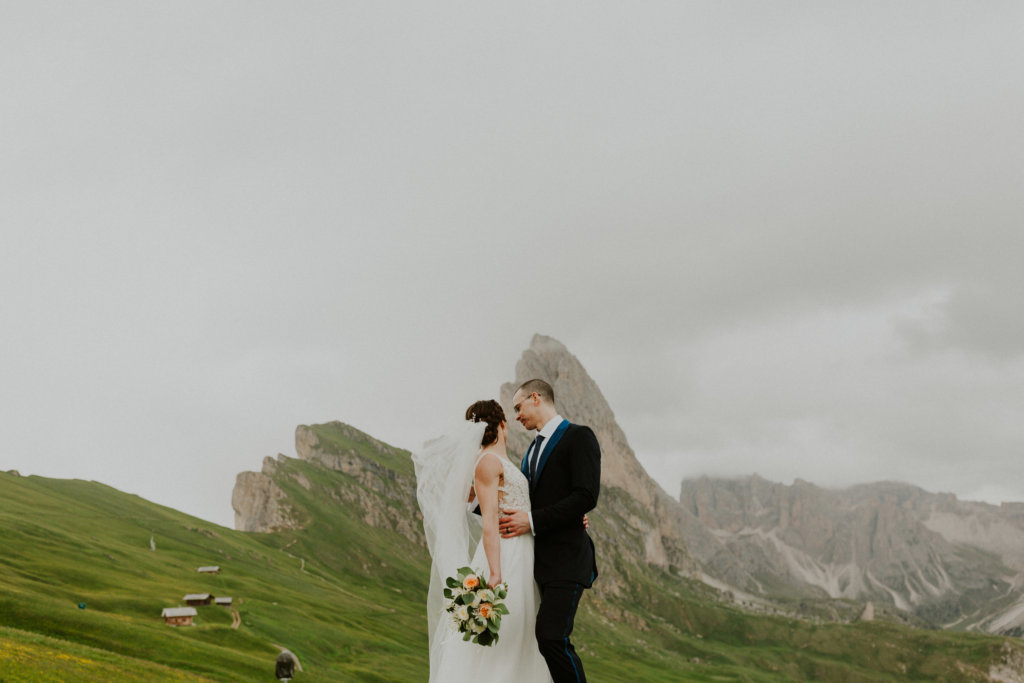 bride and groom hold each other elopement dolomites