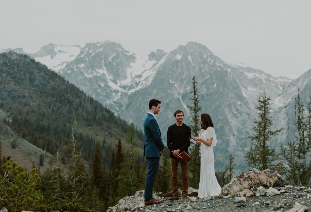bride and groom reading vows mountain landscape


