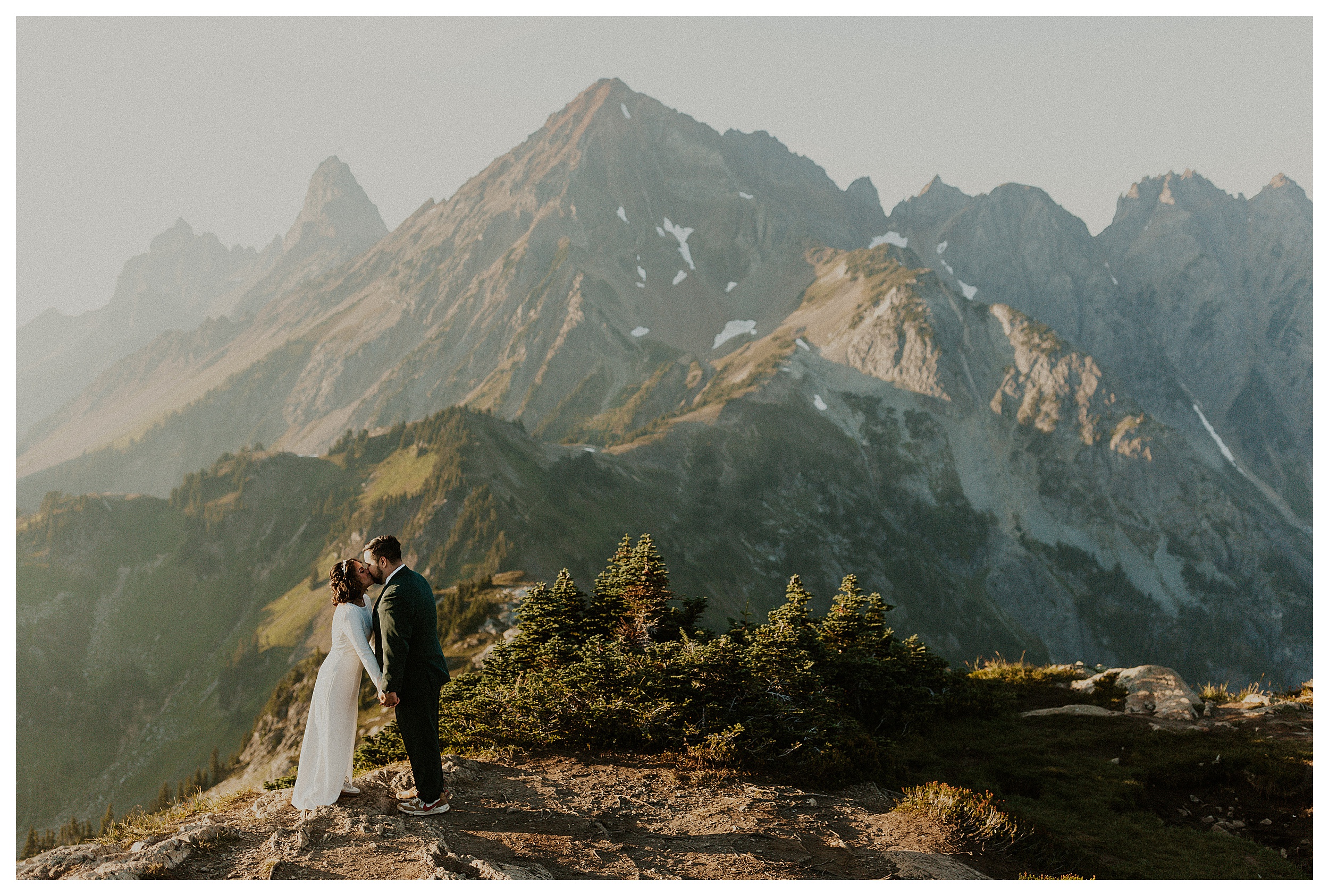 bride and groom kissing mountain landscape
