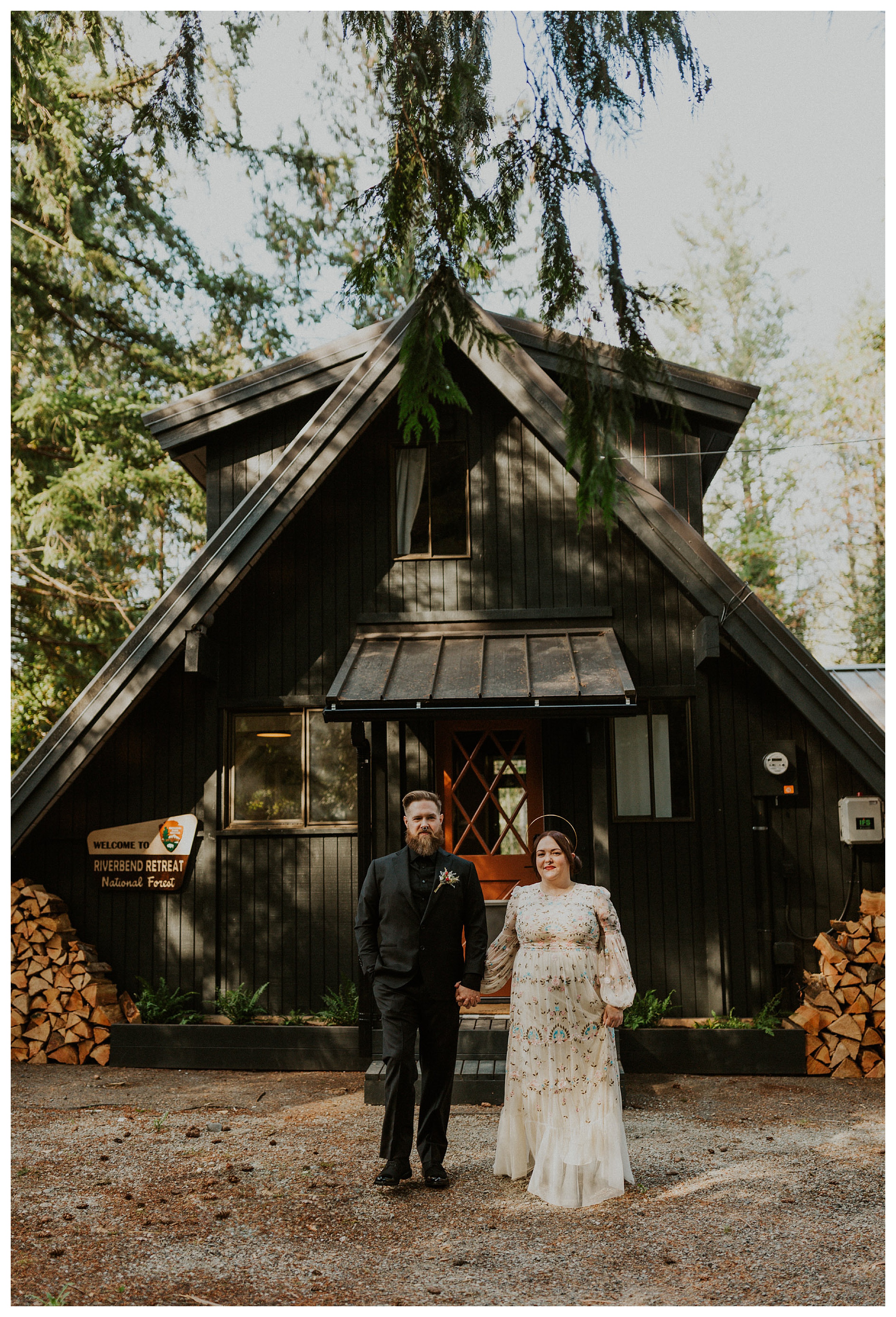 bride and groom standing together in front of a-frame cabin
